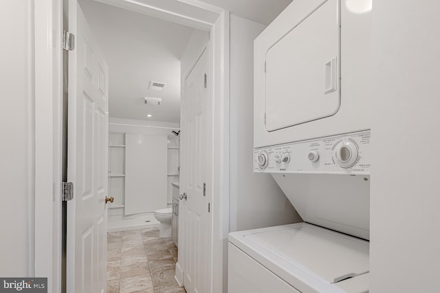 clothes washing area with stacked washer and dryer