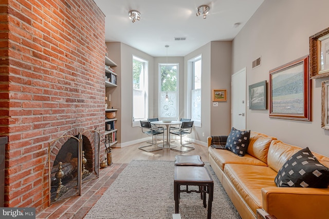 living room featuring light hardwood / wood-style flooring and a fireplace