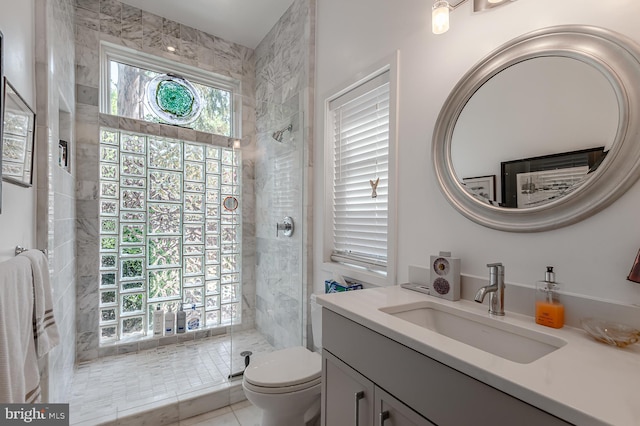 bathroom featuring vanity, a shower with shower door, toilet, and tile patterned flooring