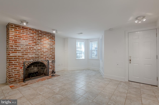 unfurnished living room with a fireplace and light tile patterned floors