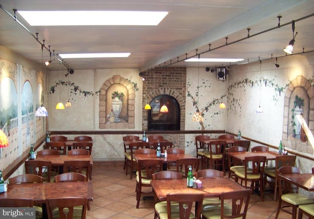 tiled dining room with a fireplace