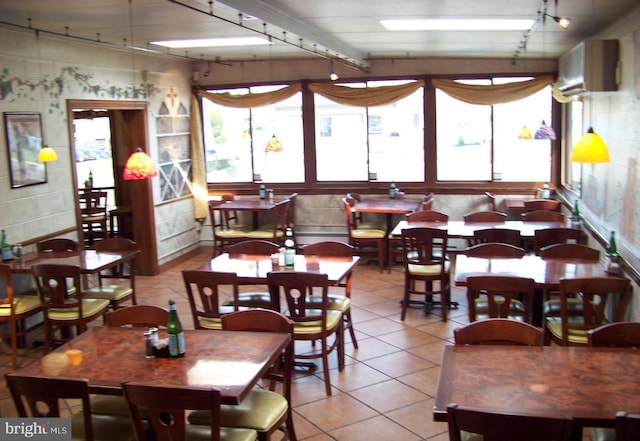 tiled dining area featuring rail lighting