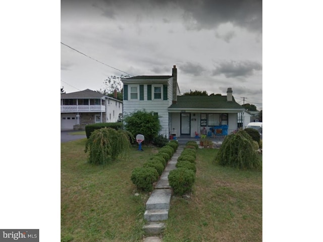 view of front of house with a garage and a front lawn