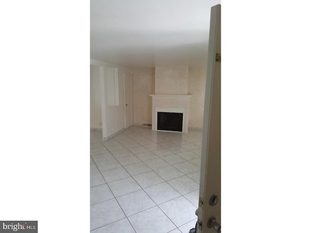 unfurnished living room featuring light tile patterned floors