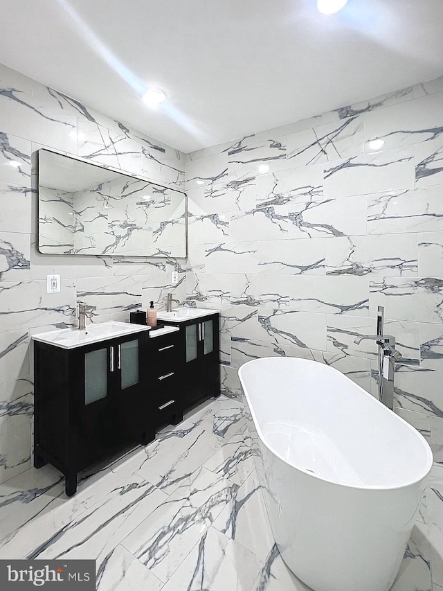 bathroom with a tub and vanity