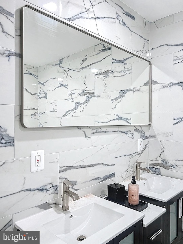 bathroom with vanity and tile walls