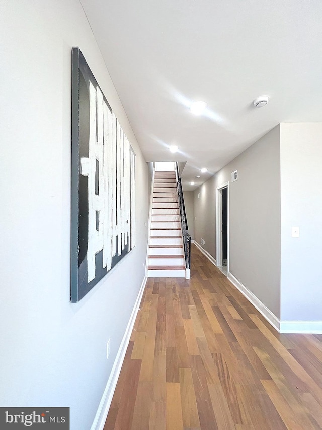 stairs featuring hardwood / wood-style flooring