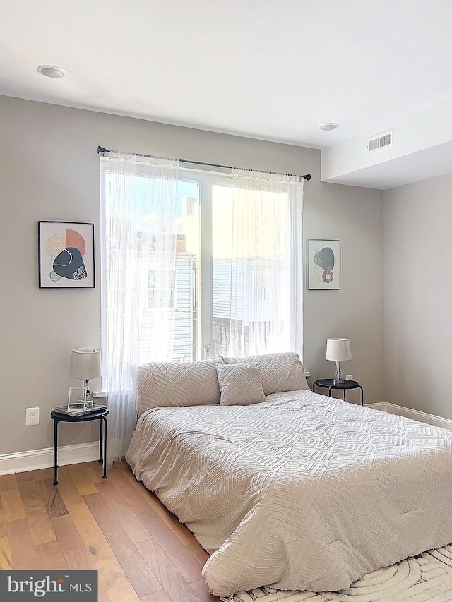 bedroom with hardwood / wood-style flooring