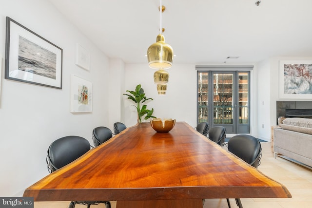 dining area featuring visible vents and a tile fireplace