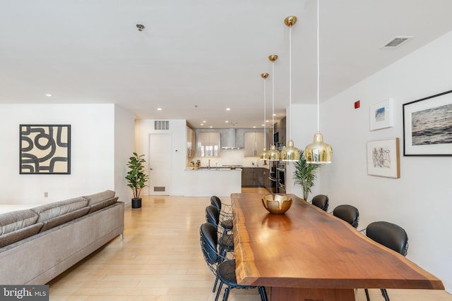 dining area featuring light wood-style floors, visible vents, and recessed lighting