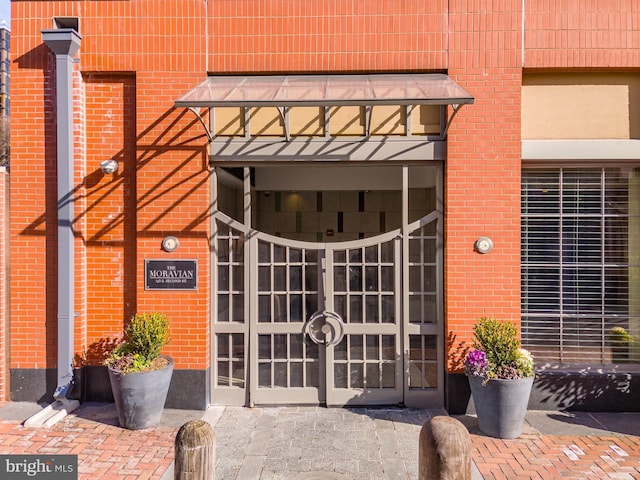 doorway to property with french doors and brick siding