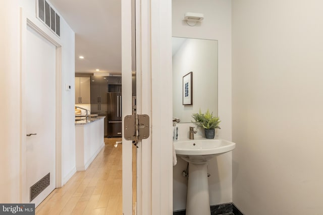 bathroom with wood finished floors, visible vents, and recessed lighting