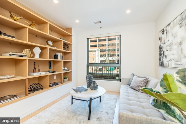 living area featuring visible vents and recessed lighting