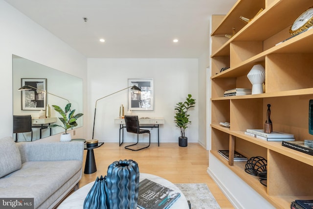 living room with baseboards, light wood-style flooring, and recessed lighting