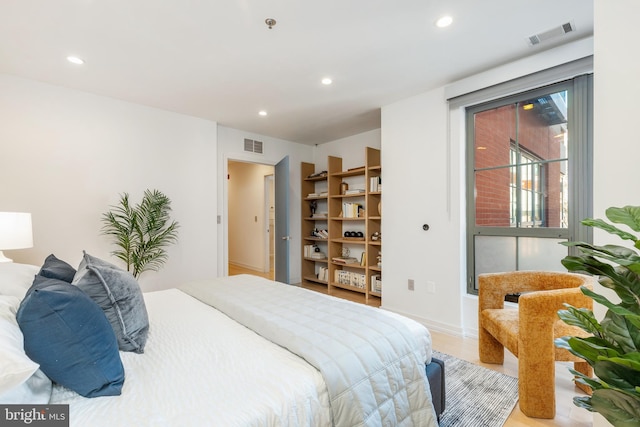 bedroom with visible vents, wood finished floors, and recessed lighting