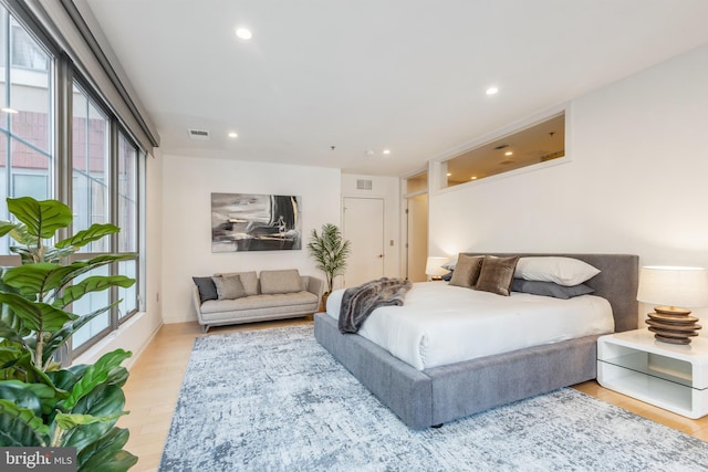 bedroom featuring light wood-type flooring, visible vents, and recessed lighting