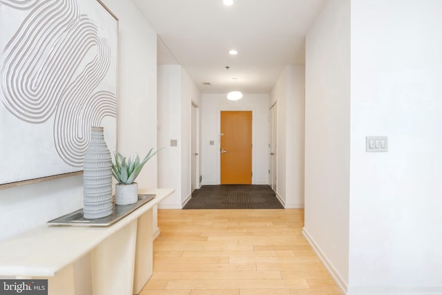 hall featuring recessed lighting, visible vents, baseboards, and wood finished floors