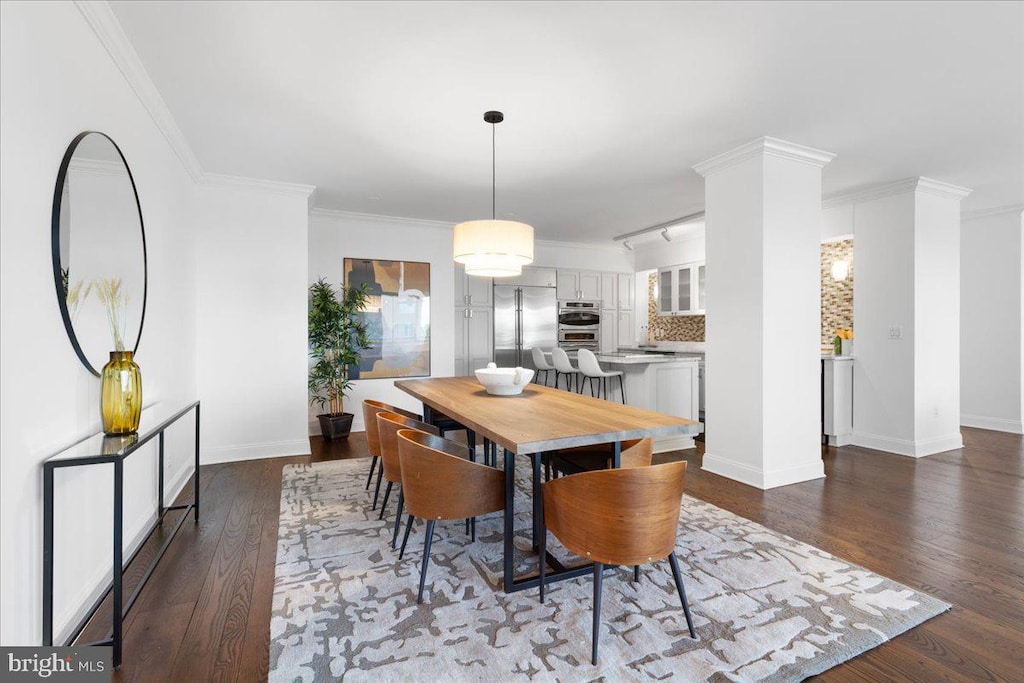 dining space featuring crown molding and dark hardwood / wood-style flooring