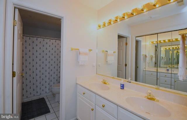 bathroom featuring walk in shower, vanity, tile patterned flooring, and toilet