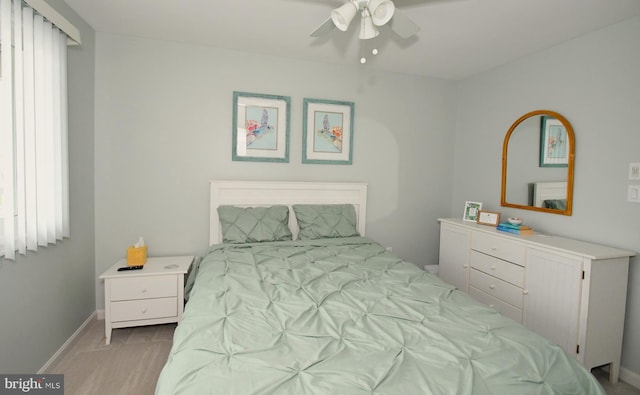 bedroom with light wood-type flooring and ceiling fan