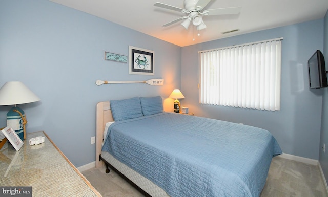 bedroom with ceiling fan and light carpet