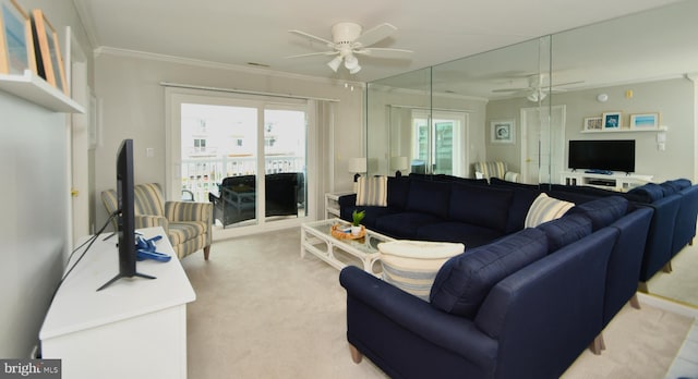 carpeted living room with ornamental molding and ceiling fan