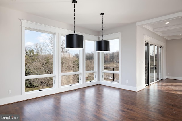 unfurnished dining area with a wealth of natural light, beamed ceiling, and dark hardwood / wood-style floors