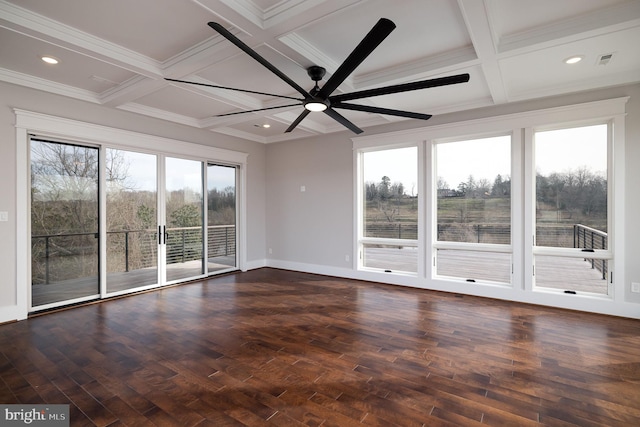 unfurnished room with beamed ceiling, dark hardwood / wood-style floors, ceiling fan, and a wealth of natural light