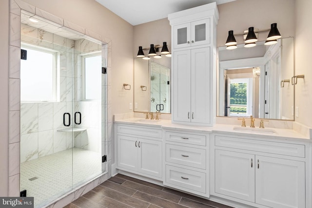 bathroom featuring vanity and an enclosed shower