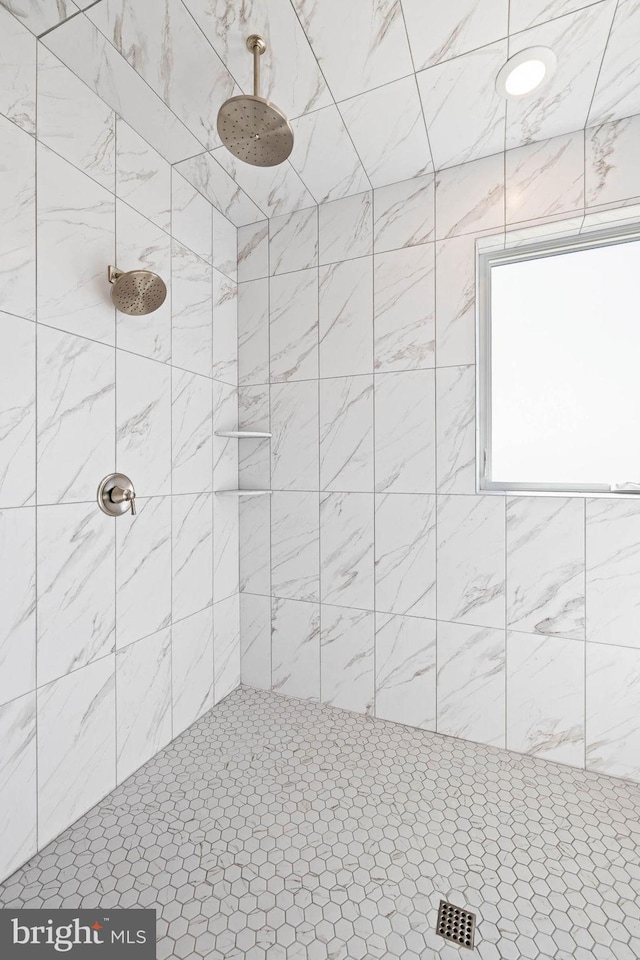 bathroom with tiled shower