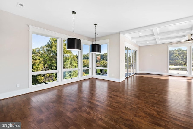 interior space featuring beam ceiling, coffered ceiling, dark wood-type flooring, and a wealth of natural light