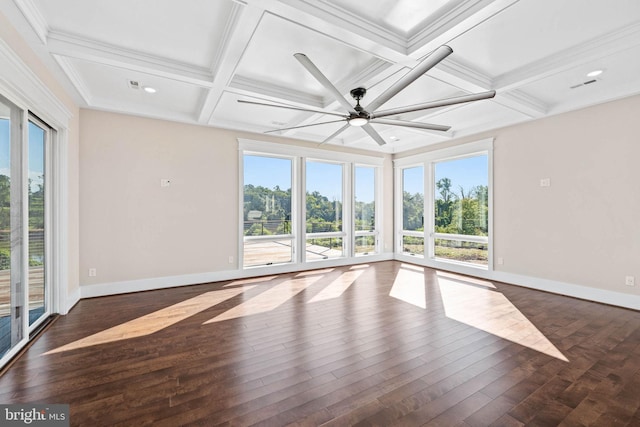 spare room featuring a wealth of natural light, ceiling fan, and dark wood-type flooring