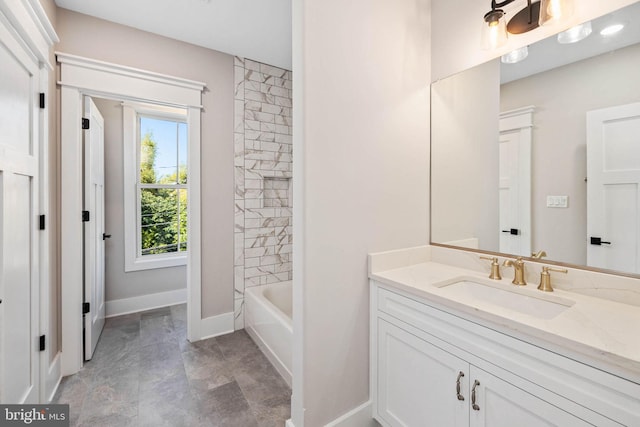 bathroom featuring tiled shower / bath combo and vanity