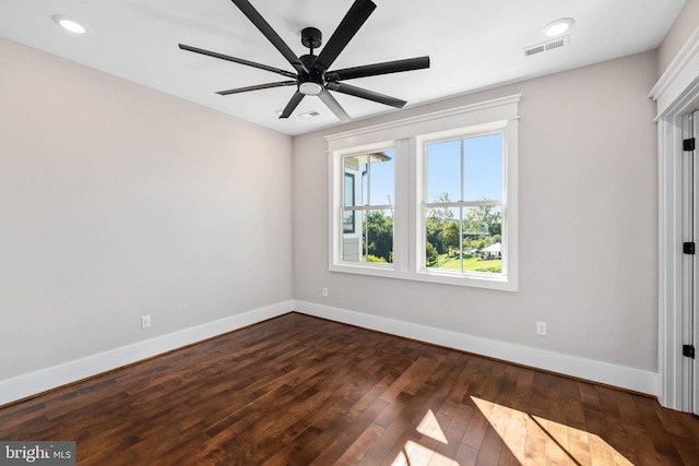 unfurnished room featuring dark hardwood / wood-style flooring and ceiling fan