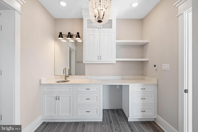 bathroom featuring vanity, an inviting chandelier, and hardwood / wood-style flooring