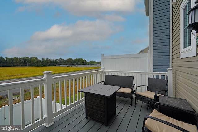 wooden terrace featuring a lawn