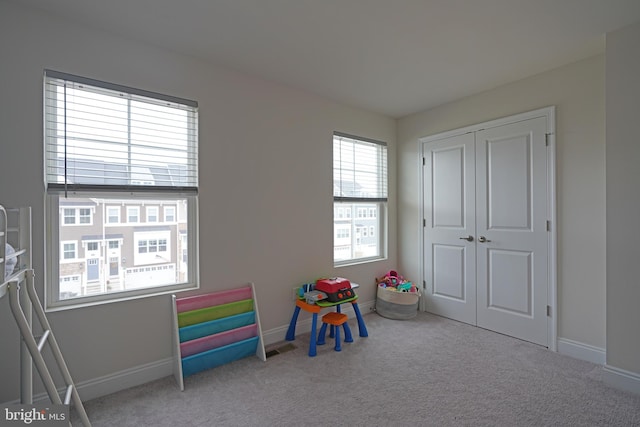 rec room featuring light colored carpet