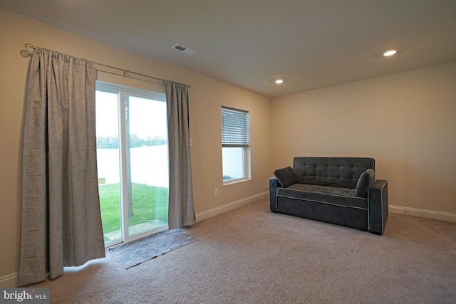 living area featuring light colored carpet