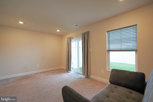 living area with light colored carpet