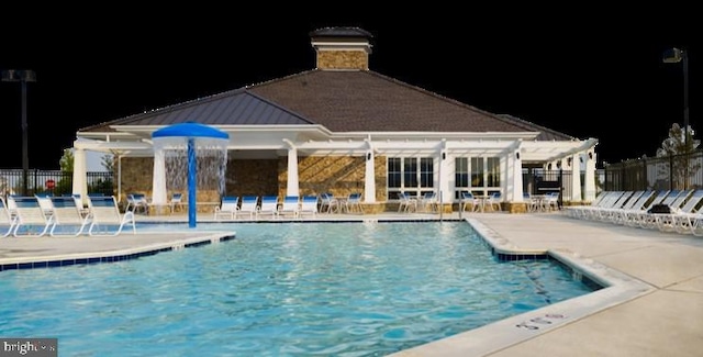 view of pool with a patio area and pool water feature