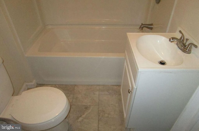 bathroom featuring vanity, a bathtub, toilet, and tile patterned floors