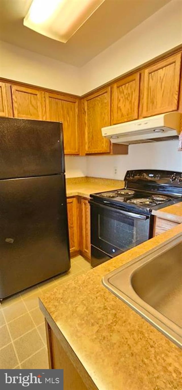 kitchen featuring sink and black appliances