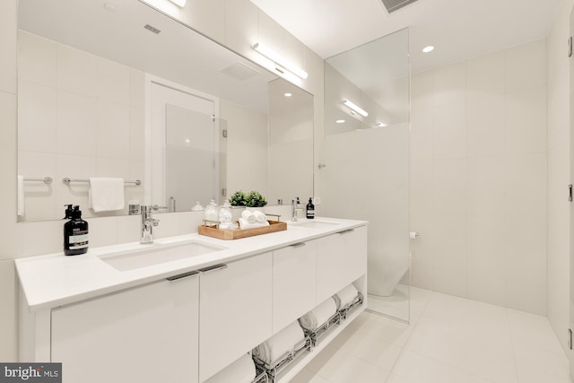 bathroom featuring tile patterned floors, vanity, and tile walls