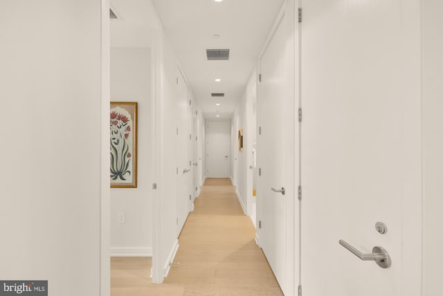 corridor with light wood-type flooring