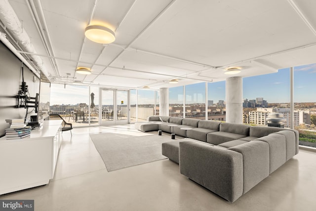 living room with a healthy amount of sunlight and floor to ceiling windows