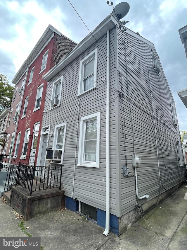 view of side of home with cooling unit