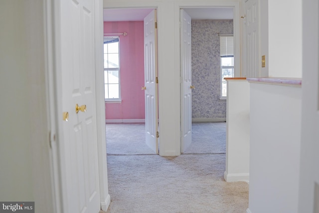 hallway with light colored carpet