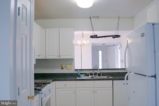 kitchen featuring white cabinets, pendant lighting, sink, white appliances, and an inviting chandelier