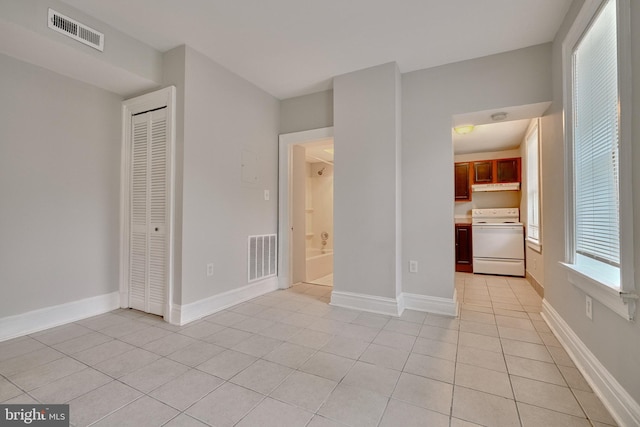 unfurnished bedroom featuring light tile patterned floors and a closet