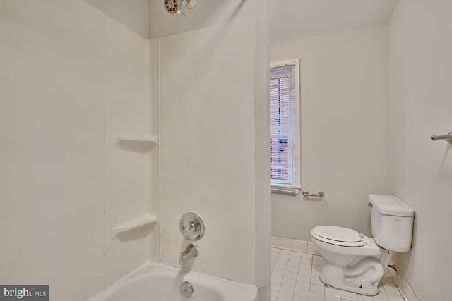 bathroom featuring tile patterned flooring, shower / washtub combination, and toilet